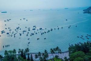 Aerial view many local culture Vietnam. Top view of local fisherman boats in the deep blue sea, tropical seascape. Travel destination Asia concept and background. photo