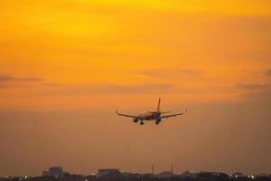 Ho Chi Minh city, Vietnam - FEB 20 2022 Airplane fly over urban areas preparing landing into Tan Son Nhat International Airport and takes off in TSN airport photo