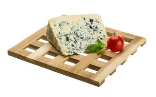 Blue cheese on wooden plate and white background photo