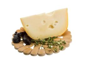 Maasdam cheese on wooden plate and white background photo