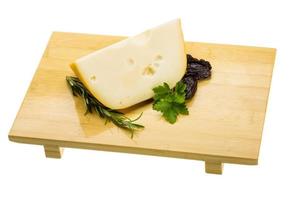 Maasdam cheese on wooden plate and white background photo