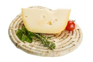 Maasdam cheese on wooden plate and white background photo