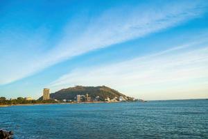 Vung Tau city aerial view with beautiful sunset and so many boats. Panoramic coastal Vung Tau view from above, with waves, coastline, streets, coconut trees and Tao Phung mountain in Vietnam. photo