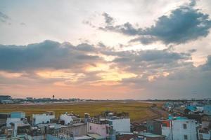 Ho Chi Minh city, Vietnam - FEB 12 2022 Airplane fly over urban areas preparing landing into Tan Son Nhat International Airport and takes off in TSN airport photo