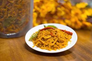 Kho Ga, Spicy Dried Chicken the Vietnamese snacks made from chicken meat with some chilly, lemon leaf and dried onion photo