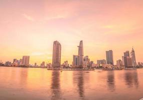 HO CHI MINH, VIETNAM - FEB 19 2022  View of Bitexco Financial Tower building, buildings, roads, Thu Thiem bridge and Saigon river in Ho Chi Minh city in sunset. High quality panorama image. photo