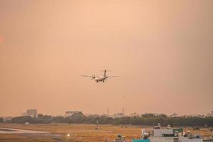 Ho Chi Minh city, Vietnam - FEB 12 2022 Airplane fly over urban areas preparing landing into Tan Son Nhat International Airport and takes off in TSN airport photo