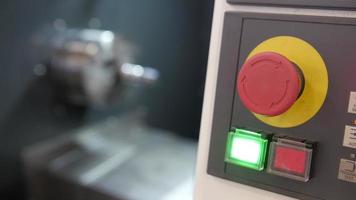 Red button of control panel machine processing of metal, industrial background