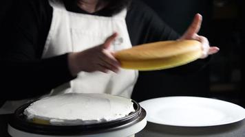 Chef making two layers cake with white cream in the middle video