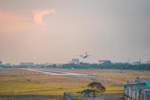 Ho Chi Minh city, Vietnam - FEB 12 2022 Airplane fly over urban areas preparing landing into Tan Son Nhat International Airport and takes off in TSN airport photo