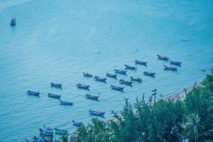 Aerial view many local culture Vietnam. Top view of local fisherman boats in the deep blue sea, tropical seascape. Travel destination Asia concept and background. photo