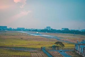 Ho Chi Minh city, Vietnam - FEB 12 2022 Airplane fly over urban areas preparing landing into Tan Son Nhat International Airport and takes off in TSN airport photo