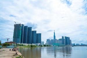 View at Landmark 81 - it is a super tall skyscraper and Saigon bridge with development buildings along Saigon river light smooth down photo