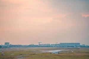 Ho Chi Minh city, Vietnam - FEB 12 2022 Airplane fly over urban areas preparing landing into Tan Son Nhat International Airport and takes off in TSN airport photo