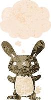 cute cartoon rabbit and thought bubble in retro textured style vector