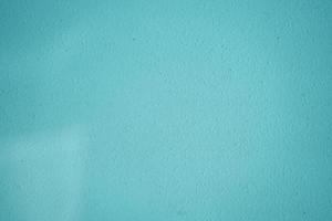 color azul de la pared de hormigón en blanco para el fondo de textura. la nueva superficie se ve áspera. forma de papel tapiz pared de textura de fondo y espacio de copia para texto. banners de diseño de superficie de cemento pintado foto