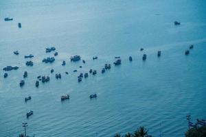 Aerial view many local culture Vietnam. Top view of local fisherman boats in the deep blue sea, tropical seascape. Travel destination Asia concept and background. photo