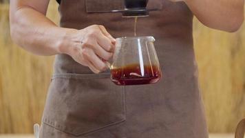 un barista professionista versa l'acqua sui fondi di caffè nel filtro come un processo manuale. cu shot, video al rallentatore 4k il filmato inviato è una disposizione di ripresa di raggruppamento