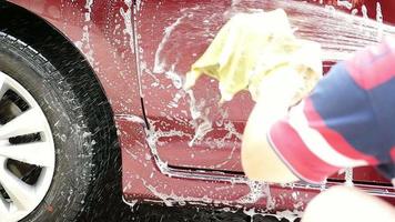 Man washing car using shampoo and water - home people car clean concept
