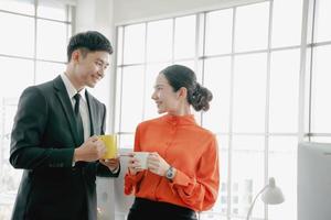 Young couple of professionals chatting during a coffee break photo