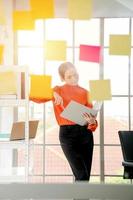 Business woman is reading documents view through window photo