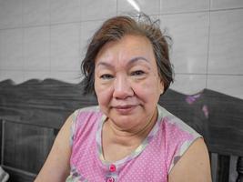Portrait photo of beautiful senior asian housewife