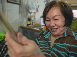 Grandmother use her tablet video conference to talk with her Grandchild photo