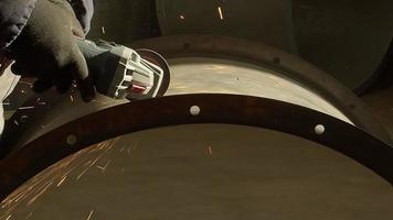 Working With Grinder is a stunning stock video that exhibits close up footage a man working with grinder cutting metal.