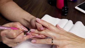 French Manicure. This video shows a girl painting french manicure. Great for suggesting positive thinking and useful as a background.