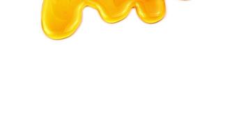 Close up view of flowing honey macro on white background. video