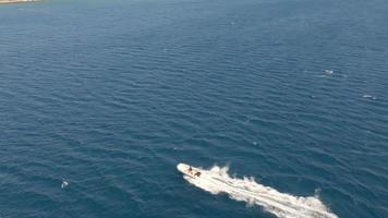 Aerial view of speeding windsurfers and powerboat. An aerial view of windsurfers and speedboat with their magnificent views are having a wonderful day in Alacati, cesme Turkey video