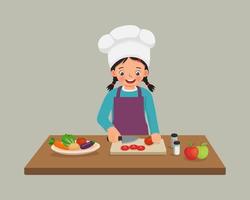cute little girl chef cooking meal cutting slicing tomato vegetable with knife in the kitchen vector