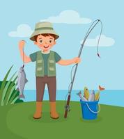 cute little boy holding big fish hook on the fishing rod standing near bucket full of fishes