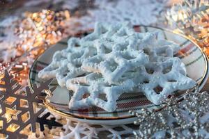 White chocolate pretzel stars on festive background photo