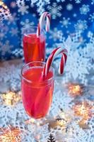 Festive Christmas drinks with candy canes on winter background photo
