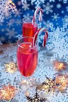 Festive Christmas drinks with candy canes on winter background photo