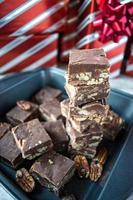 Group of fudge squares on white paper background photo