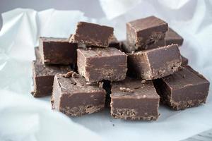 Group of fudge squares on white paper background photo