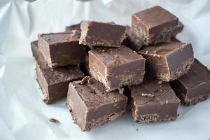 Group of fudge squares on white paper background photo