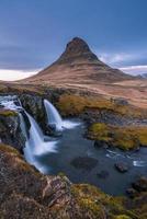 Kirkjufell mountain an iconic natural landmark of Iceland located at Snaefellsnes peninsula, near the town of Grundarfjordur. photo