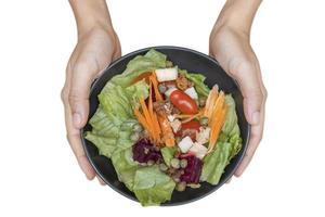 Woman's hand holding vegetable salad and eating Breakfast isolated Clipping path on white background photo