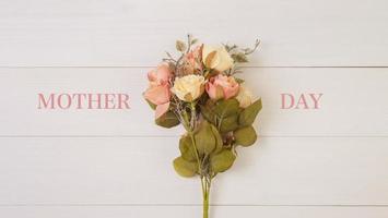 Beautiful flower on wooden background with romantic, mother day or valentine day with pastel tone, spring or summer nature background for decoration, bouquet floral for gift on desk, holiday concept. photo