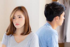 Relationship of young asian couple having problem on bed in the bedroom at home, family having conflict argument with unhappy, man and woman with issue, failure and stress together. photo