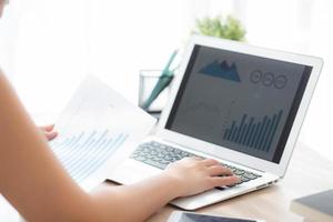 Beautiful young asian woman working laptop computer, businesswoman looking graph diagram analysis statistic data with excited and success, girl using notebook, business concept. photo