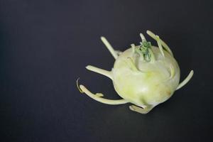 Kohlrabi with its tentacles. Black background photo