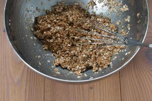 Close-up of a metallic bowl with the cookies dough. Egg beater. photo