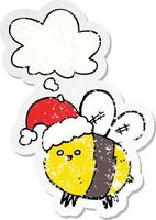 cute cartoon bee wearing christmas hat and thought bubble as a distressed worn sticker vector