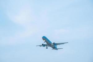 Ho Chi Minh city, Vietnam - FEB 20 2022 Airplane fly over urban areas preparing landing into Tan Son Nhat International Airport and takes off in TSN airport photo