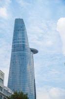 Ho Chi Minh City, VIETNAM - FEB 13 2022 Bitexco Financial Tower, skyscraper viewed from below toward a sky. Urban development with modern architecture photo