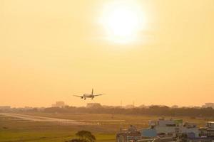 Ho Chi Minh city, Vietnam - FEB 20 2022 Airplane fly over urban areas preparing landing into Tan Son Nhat International Airport and takes off in TSN airport photo